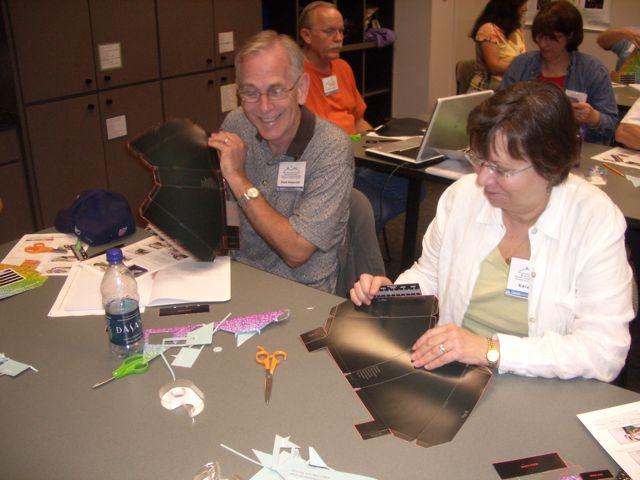 Doak and Karen cut, fold, tape.