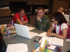 Crystal, Gavin, and Manju examine their plot.
