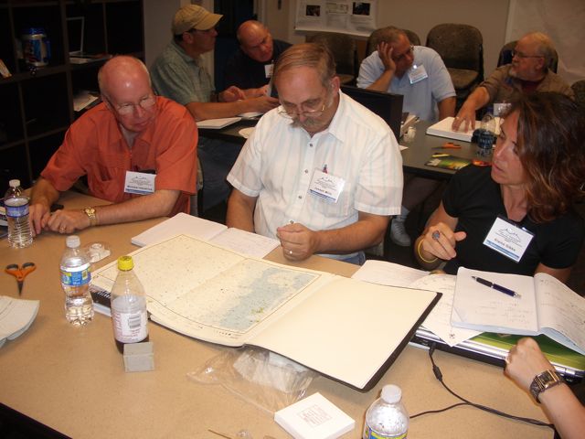 Mike H, Joseph, and Elaine use a star map.