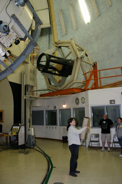 Dr. Meyer shows a model of a reflecting telescope
