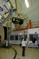 Dr. Meyer shows a model of a reflecting telescope