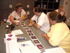 Beverely, Eric, and Kelley look for  details in the solar system formation cards.